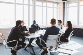 Members of a board of directors having a discussion at a modern conference table